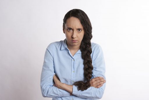 A woman showing signs of anger and annoyance.