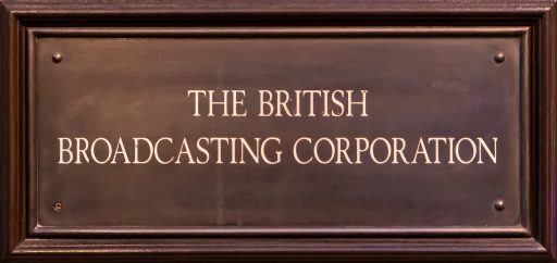 A wooden plaque containing the text "The British Broadcasting Corporation". 