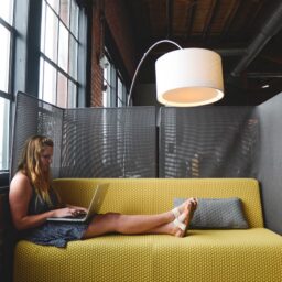 A female entrepreneur and businesswoman working on a laptop in a fashionable office.