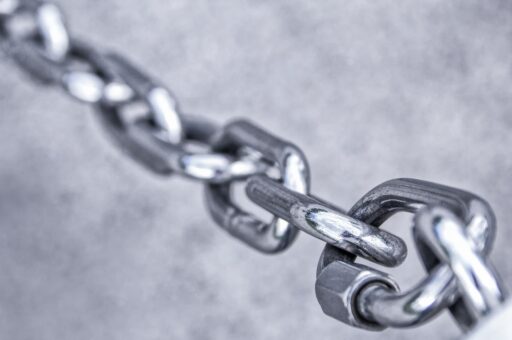 A chain made out of metal links. It is used here as a visual metaphor for the blockchain.